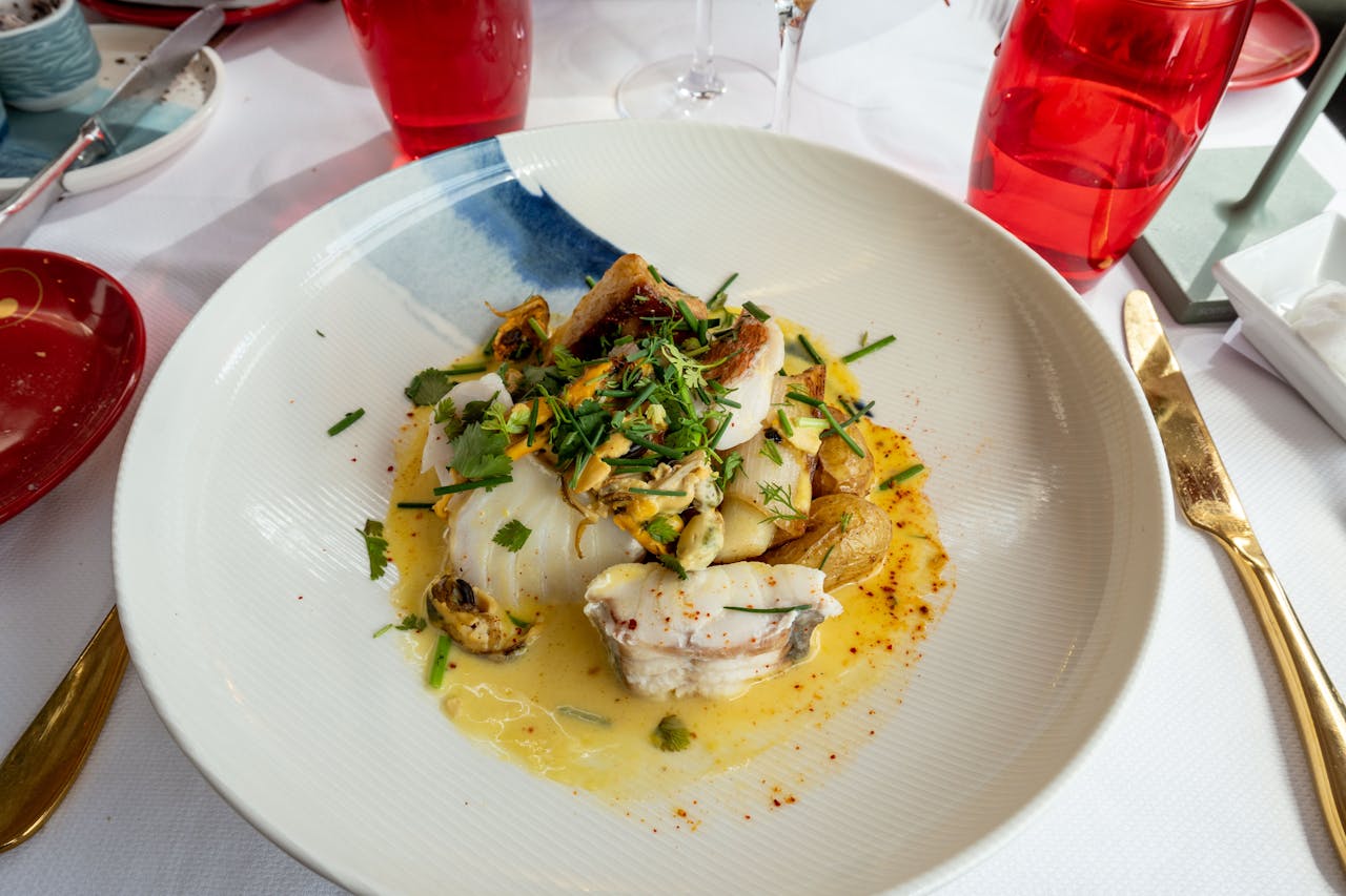 Exquisite fish dish garnished with fresh herbs and served elegantly in Boulogne-sur-Mer.